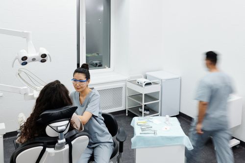 A dentist providing care to a patient in a clinic